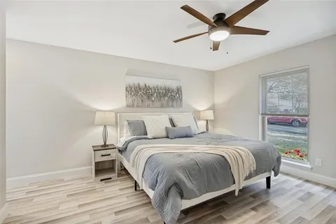 a bedroom with a bed and wooden floor