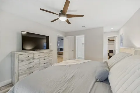 a bedroom with a large bed and a flat screen tv