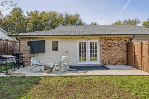 a view of a house with backyard porch and sitting area