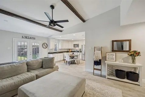 a living room with furniture a fireplace and kitchen view