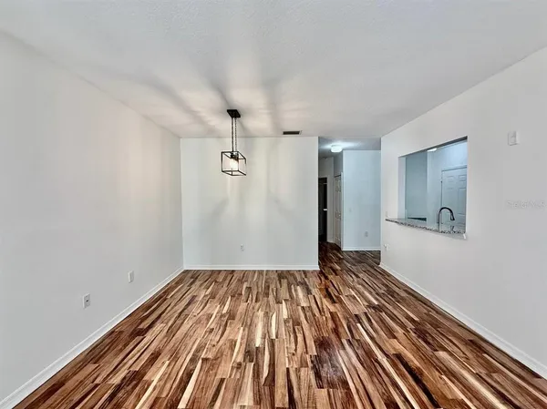 a view of a room with wooden floor