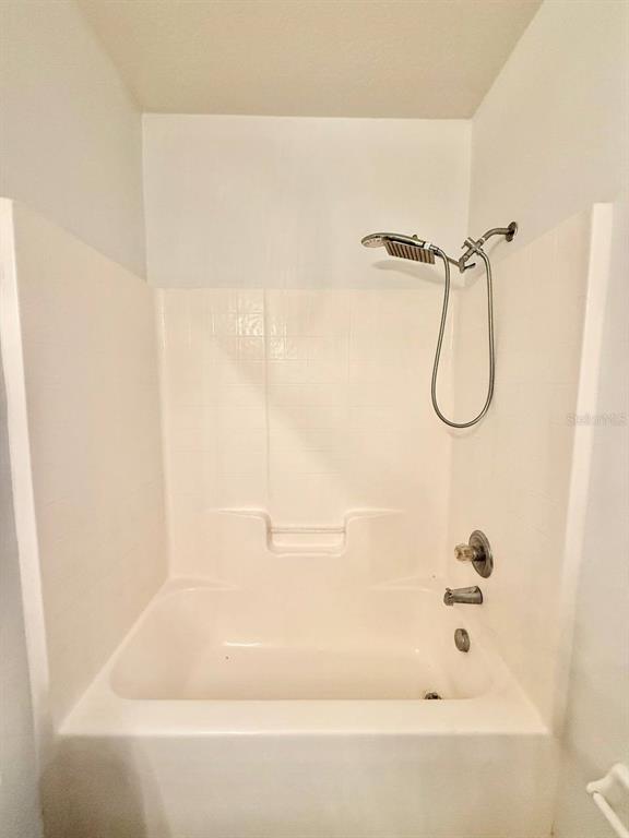 6014 Portsdale Place, Unit 202 Riverview, FL 33578 - Photo 17 of 29 a bathroom with a bath tub with a shower
