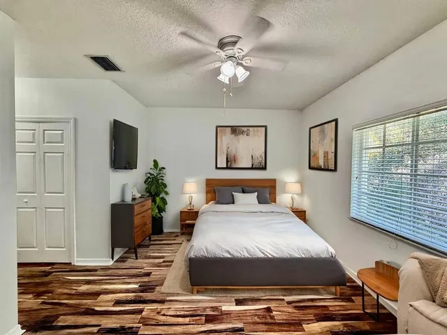 a bedroom with a bed and a flat screen tv