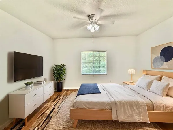 a bedroom with a bed and a flat screen tv
