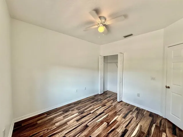 a view of a room with wooden floor