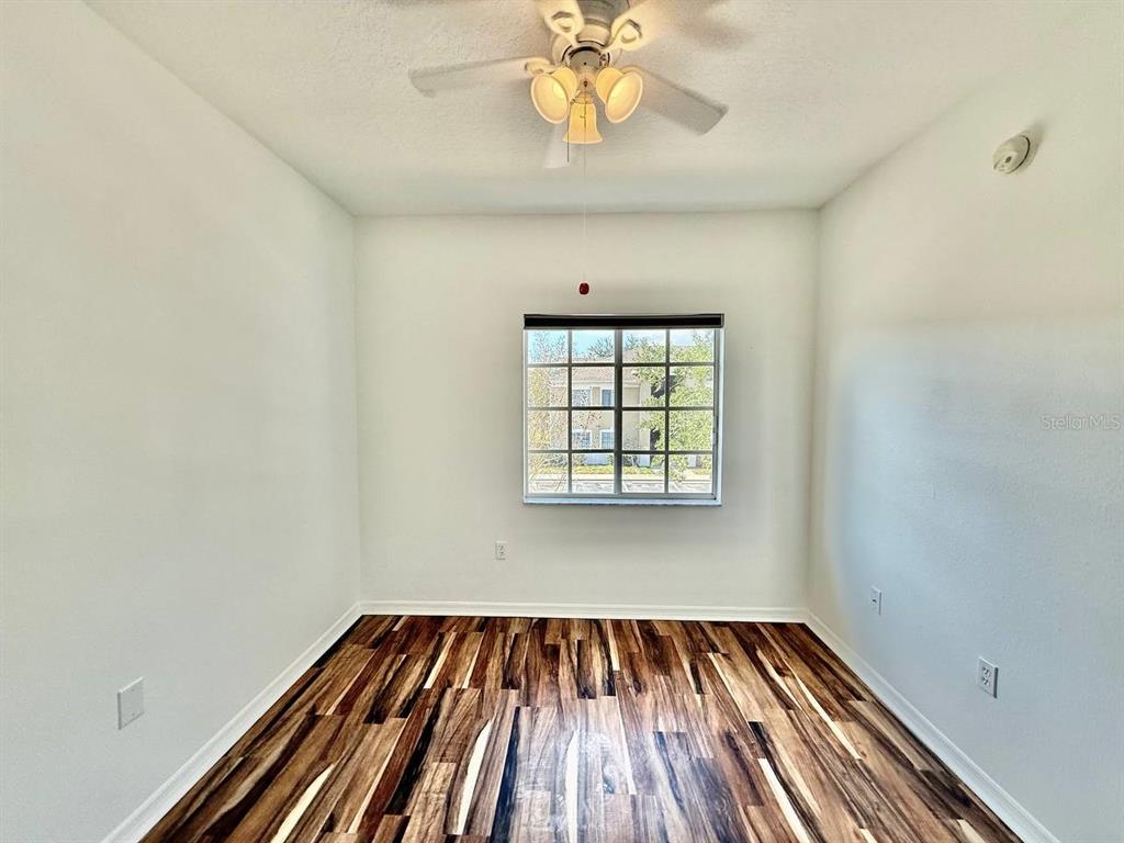6014 Portsdale Place, Unit 202 Riverview, FL 33578 - Photo 22 of 29 wooden floor in an empty room with a window
