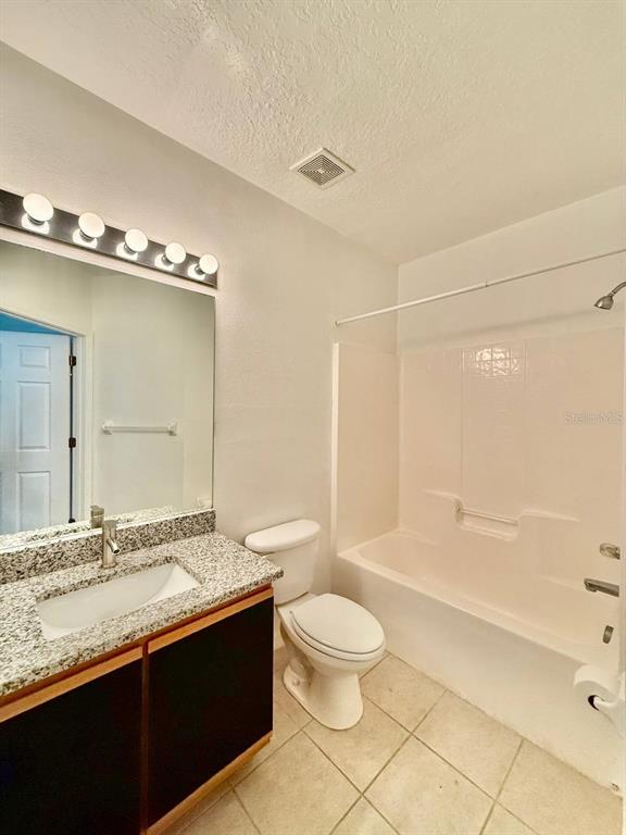 6014 Portsdale Place, Unit 202 Riverview, FL 33578 - Photo 25 of 29 a bathroom with a granite countertop sink toilet mirror and bathtub