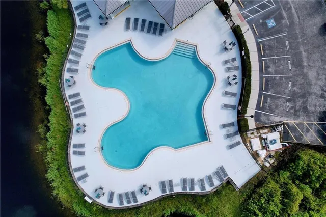 an aerial view of a house with swimming pool and garden