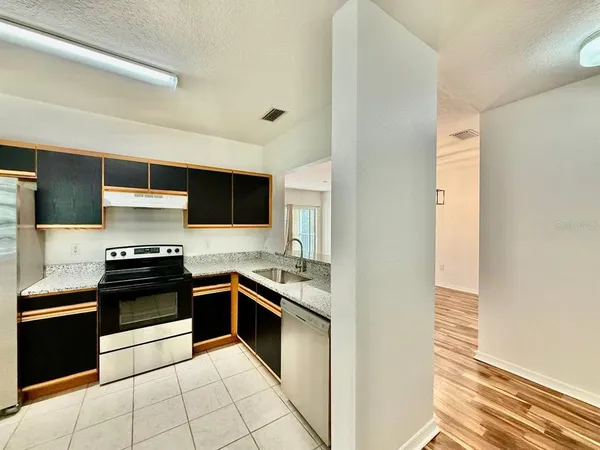 a kitchen with stainless steel appliances granite countertop a stove and a sink