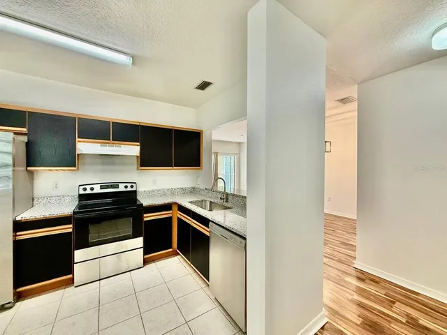a kitchen with stainless steel appliances granite countertop a stove and a sink