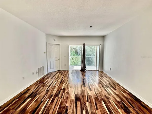 a view of wooden floor in an empty room