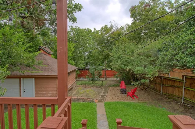 a view of a backyard with couches chair and grass
