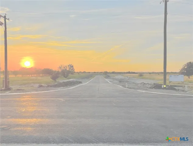 a view of a road with an ocean view