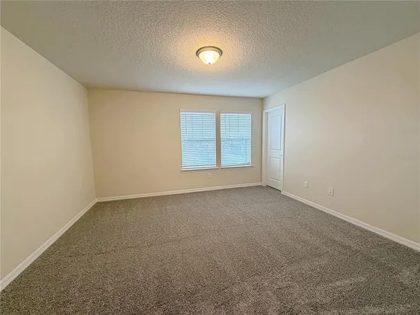 an empty room with windows and entrance