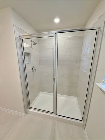 a bathroom with a glass shower door
