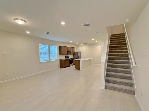 a view of kitchen and hall with wooden floor