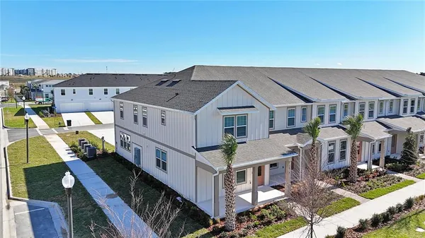 a view of a house with roof deck and furniture