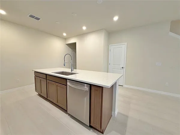 a kitchen with a sink and a refrigerator