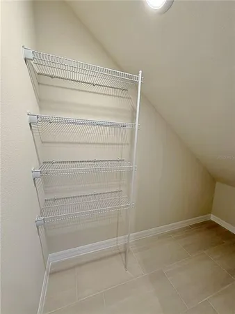 a view of walk in closet with empty racks