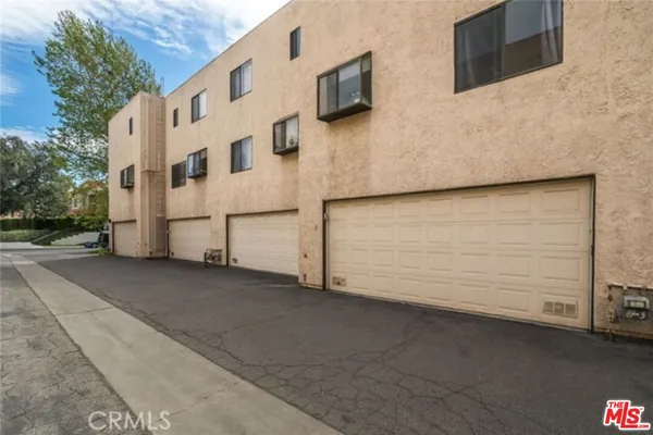a view of a house with parking space