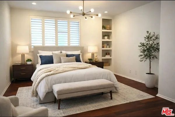 a bed room with a bed window and a table