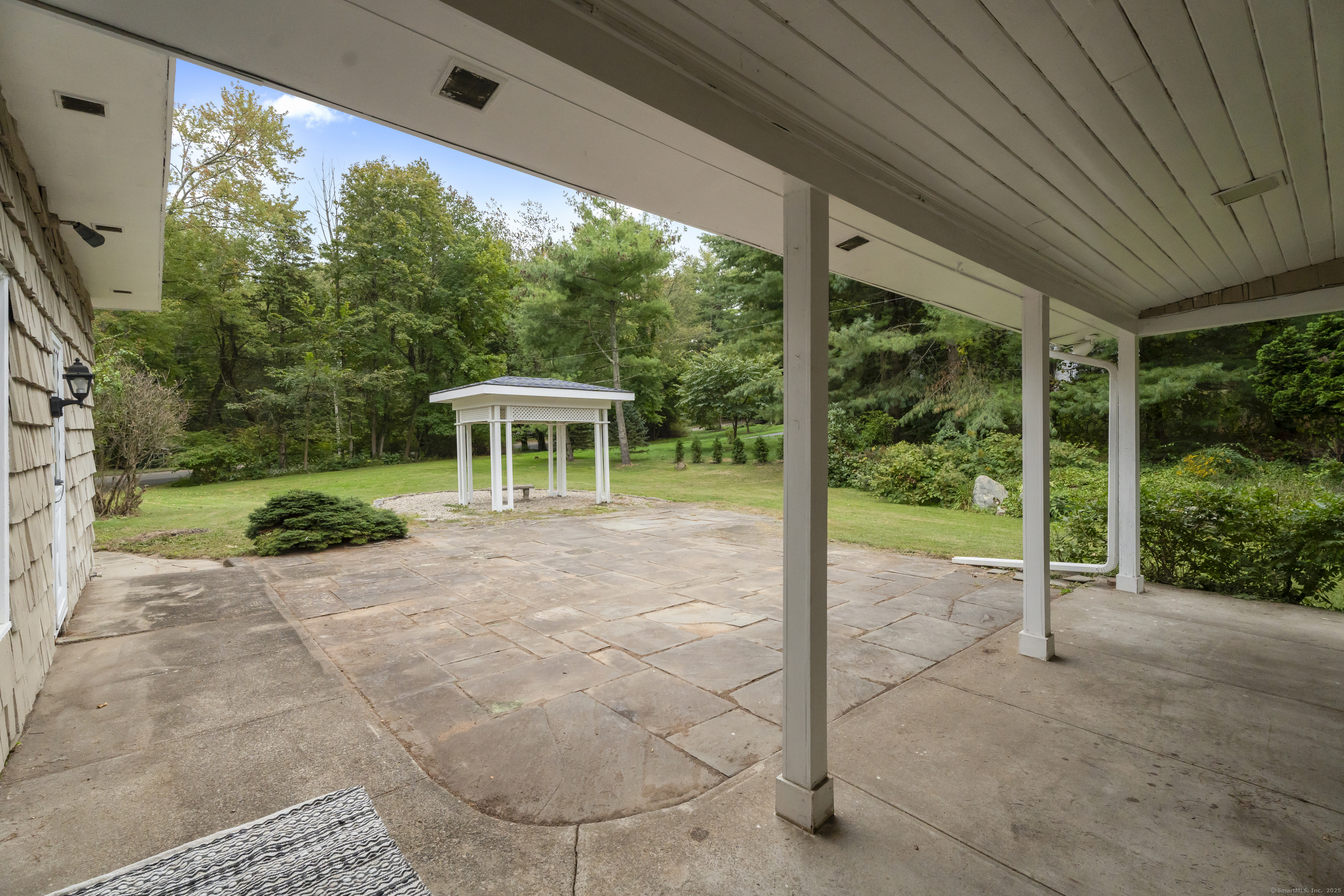 46 Tumblebrook Road Woodbridge, CT 06525 - Photo 28 of 37 Blue stone patio is waiting for a firepit, outdoor kitchen, lounge area?