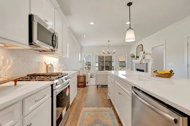 a living room with furniture chandelier and a chandelier