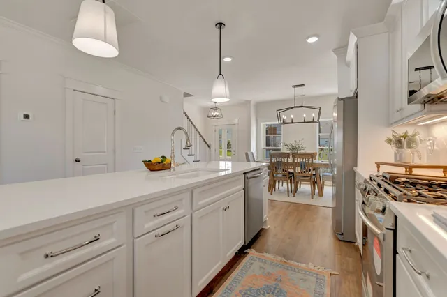 a living room with furniture a fireplace and a chandelier