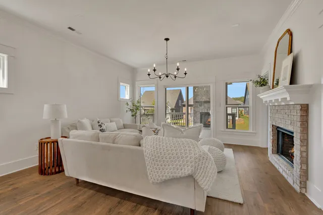 a spacious bedroom with a bed and a chandelier