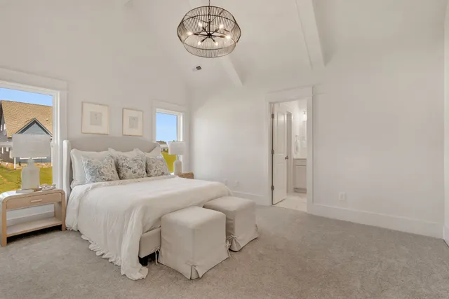 a living room with furniture a flat screen tv and a large window