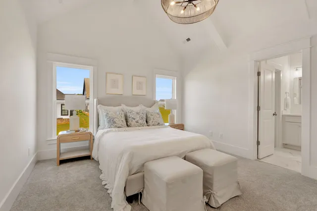 an empty room with windows and ceiling fan