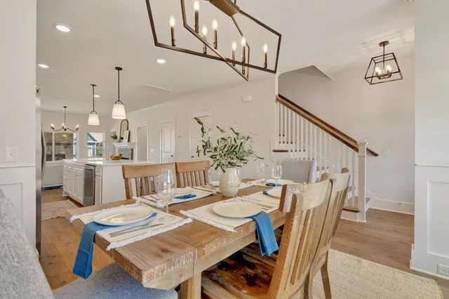 a large white kitchen with lots of counter space a sink appliances and cabinets