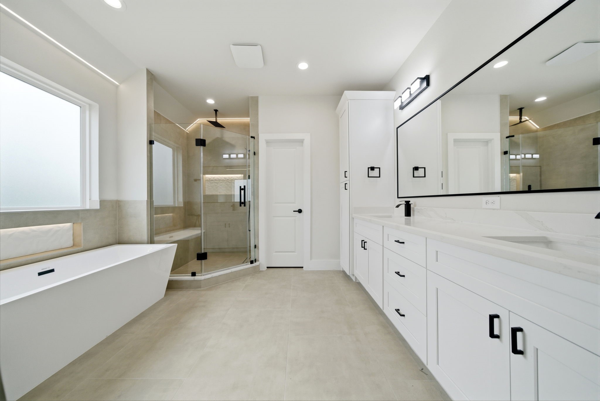 328 Janisch Road, Unit C Houston, TX 77018 - Photo 25 of 46 a bathroom with a double vanity sink a large mirror a shower and bathtub