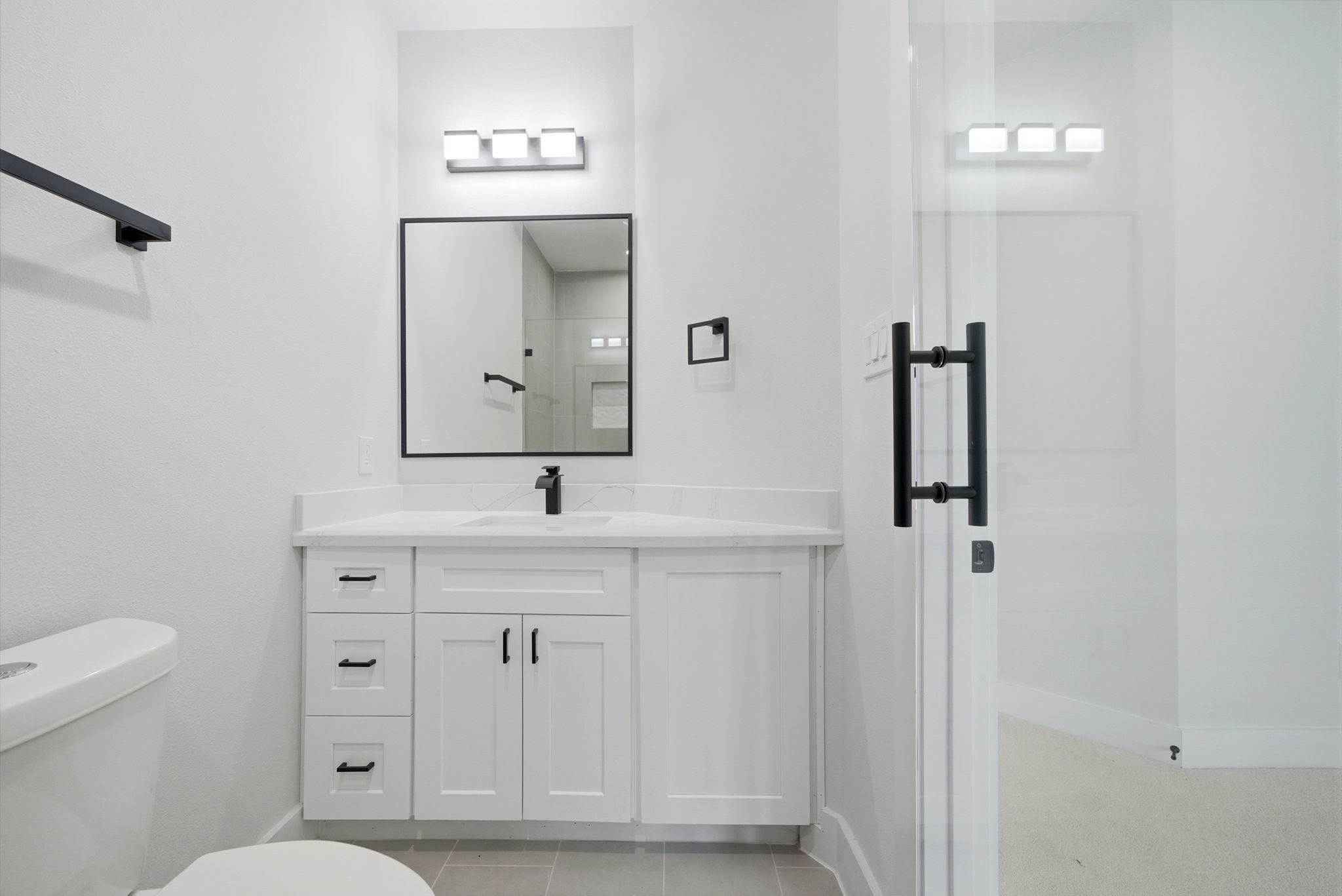 328 Janisch Road, Unit C Houston, TX 77018 - Photo 39 of 46 a bathroom with a toilet a sink a mirror and vanity