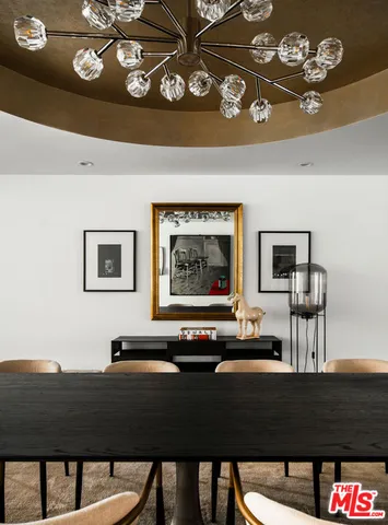 a view of a room with furniture and chandelier
