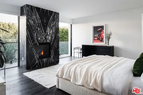 a bedroom with a bed and a fireplace