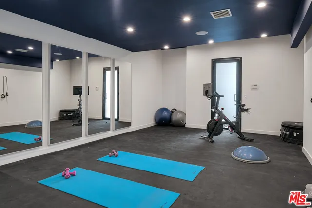 a room with gym equipment and a table