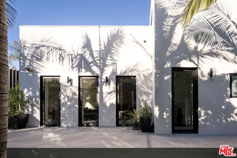 a front view of a building with a garden