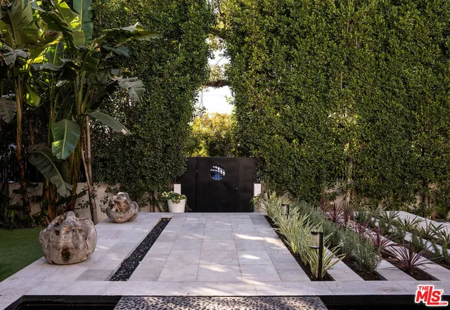 a view of a porch with potted plants