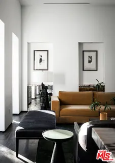 a living room with furniture and a lamp