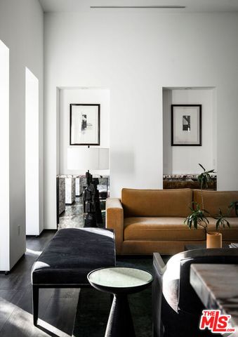 a living room with furniture and a lamp