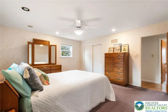 a bedroom with a bed dresser and a window