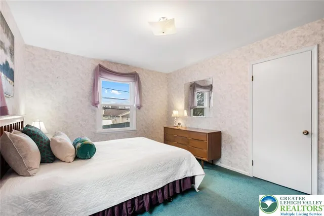 a bedroom with a bed and dresser