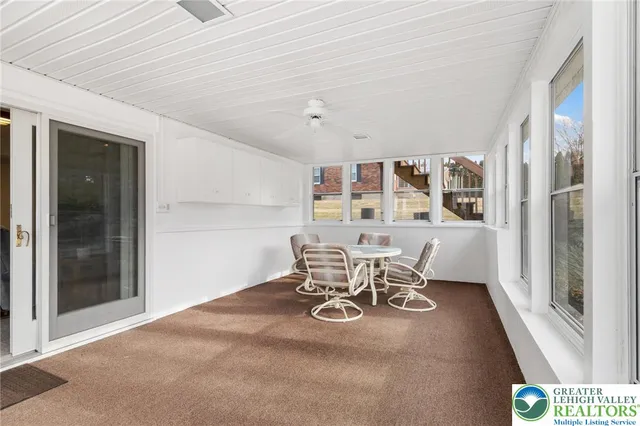 a view of a dining room with furniture and a chandelier