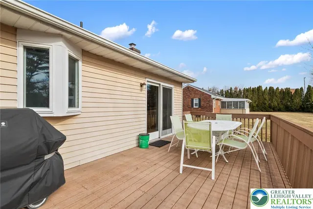 a balcony with wooden floor and outdoor seating