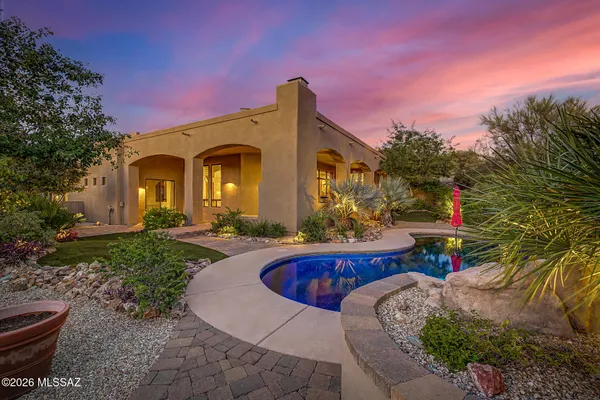 a front view of a house with swimming pool yard fire pit and outdoor seating