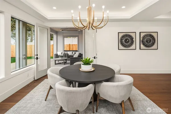 a dining room with furniture and a potted plant