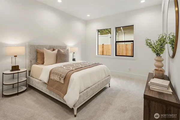 a bed room with a bed and a potted plant