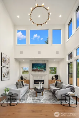a living room with furniture a fireplace and a large window