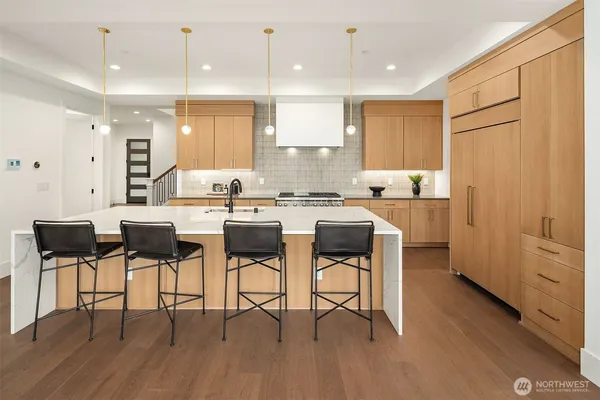 a kitchen with a dining table chairs and white cabinets